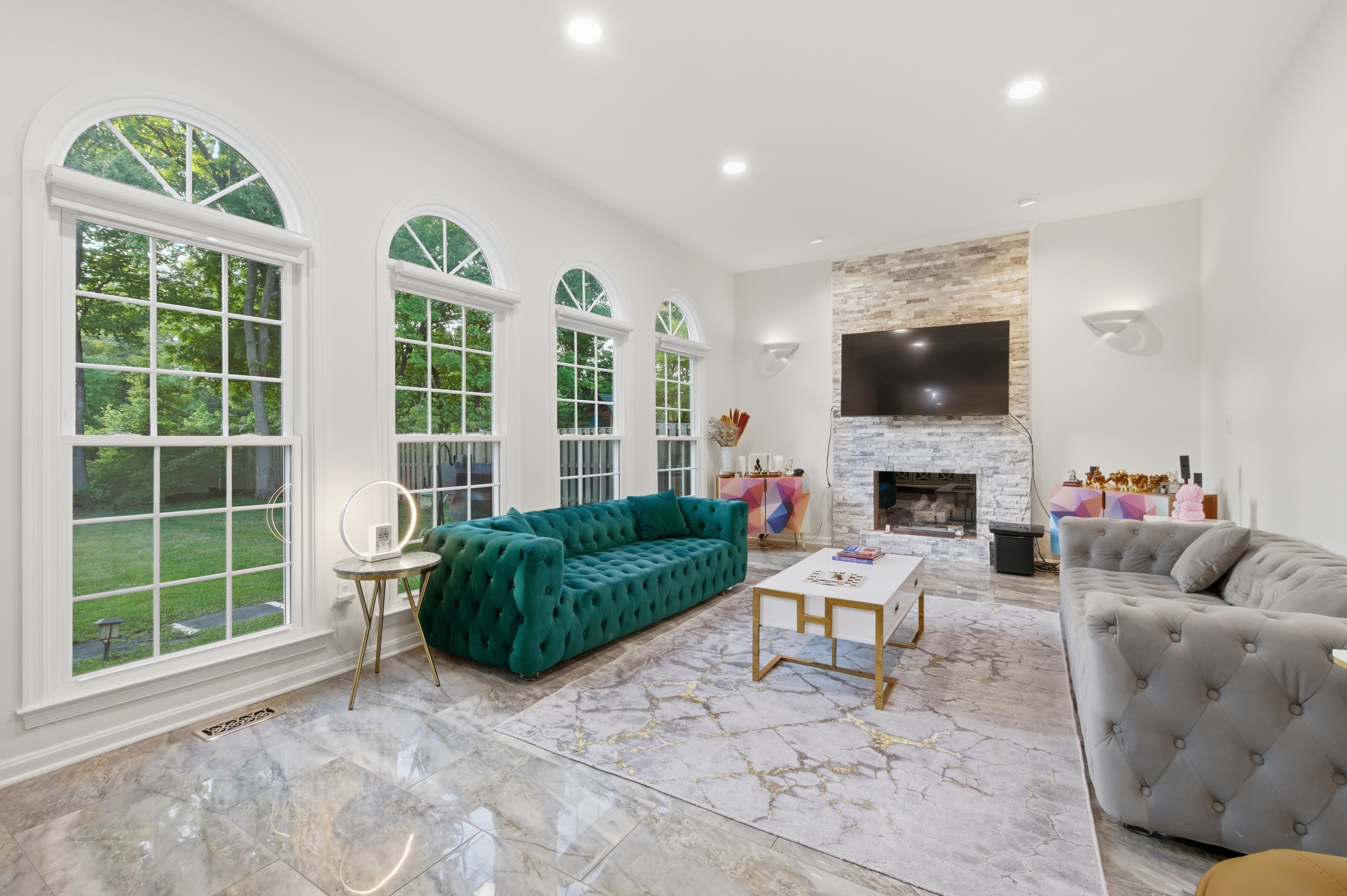 Pricing your home right the first time in Northern Virginia — interior of a Cornerstone Realty Group listing showing stone fireplace and arched windows
